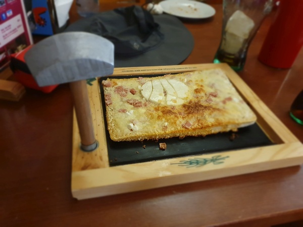 Strange way to serve a pizza - with a tiny hammer. We saw that several times.