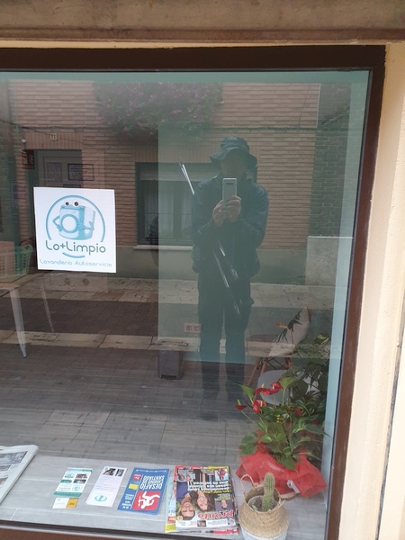 Day 14: Another day with soaking rain. Took a photo of myself through a window in Carrión de los Condes.