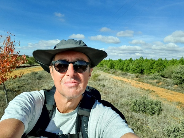 2 km outside Astorga. Beautiful road, beautiful weather and a beautiful hiker.