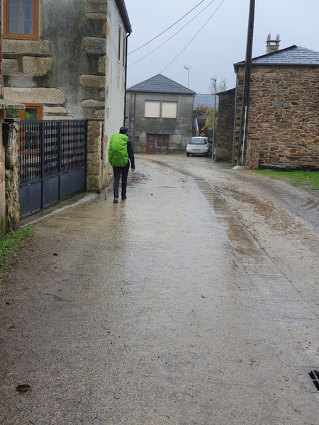 Walking in rain through Ligonde. The camera does not catch the drops very well. The lady in front is Swiss and began her journey in Switzerland.