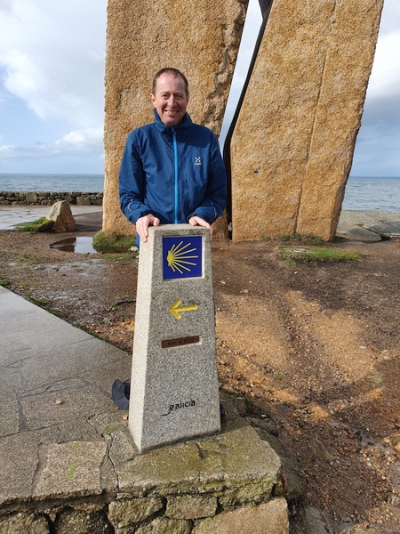 Claus at the milestone next to commemoration mark